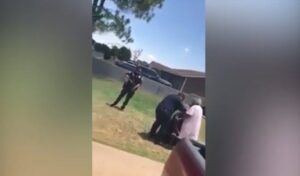 Watch: Black Texas Man’s Grandmother Stands Between Him and Gun-Wielding Police Officers…All Because He Reportedly Ran a Stop Sign
