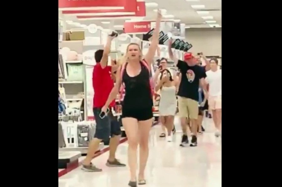 Anti-mask group shouts at store customers to 'take off your mask'